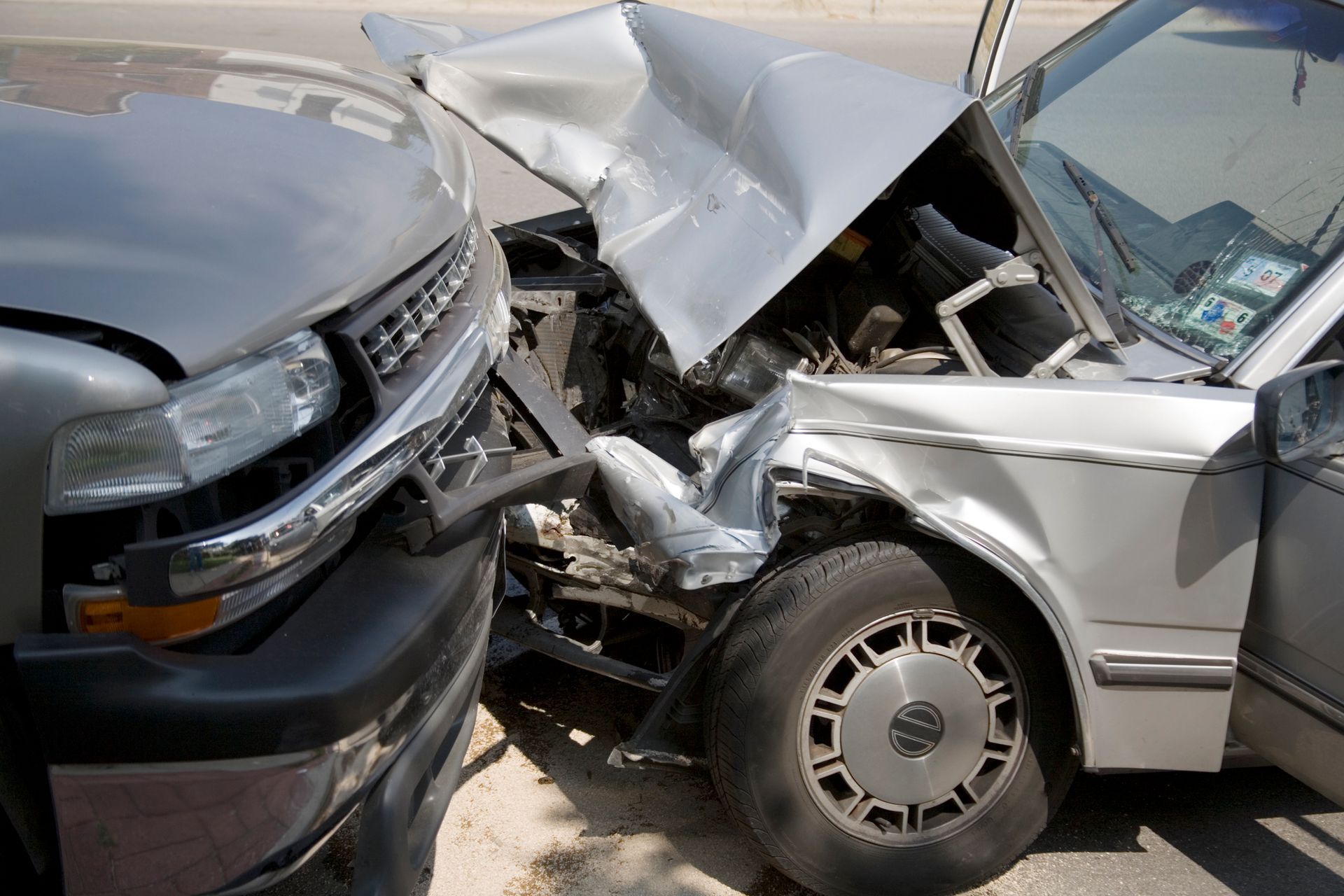 A truck and a car are involved in a car accident.