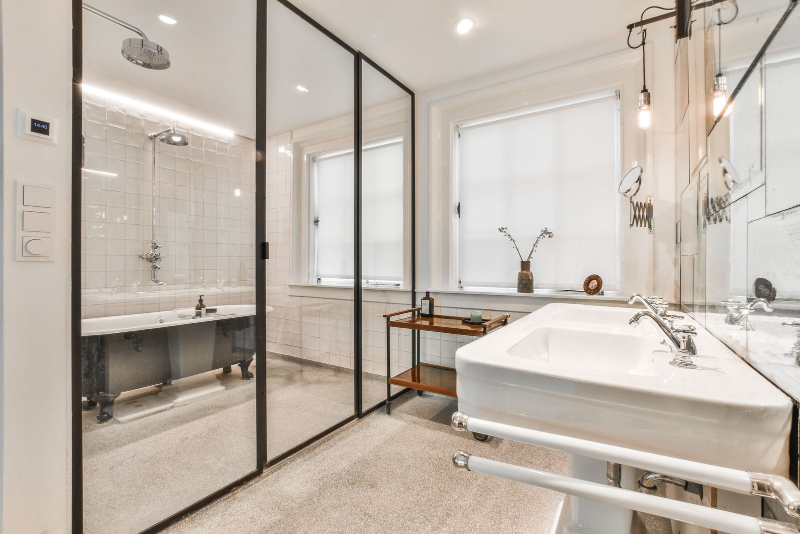 A bathroom with a sink , tub , shower and mirror.