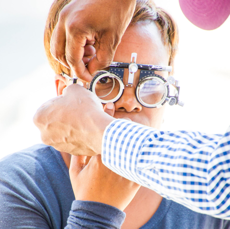 Optometrist examining the eyes of the kid
