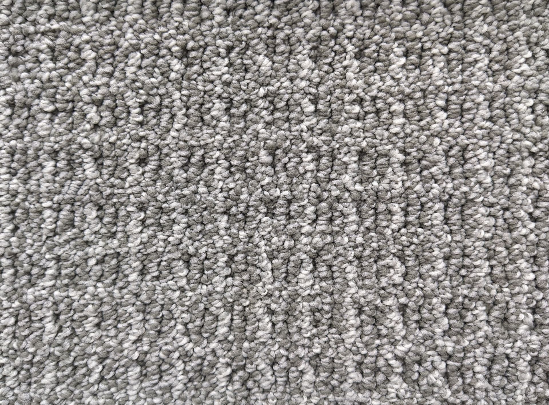 Gray carpet with a patterned, textured surface.