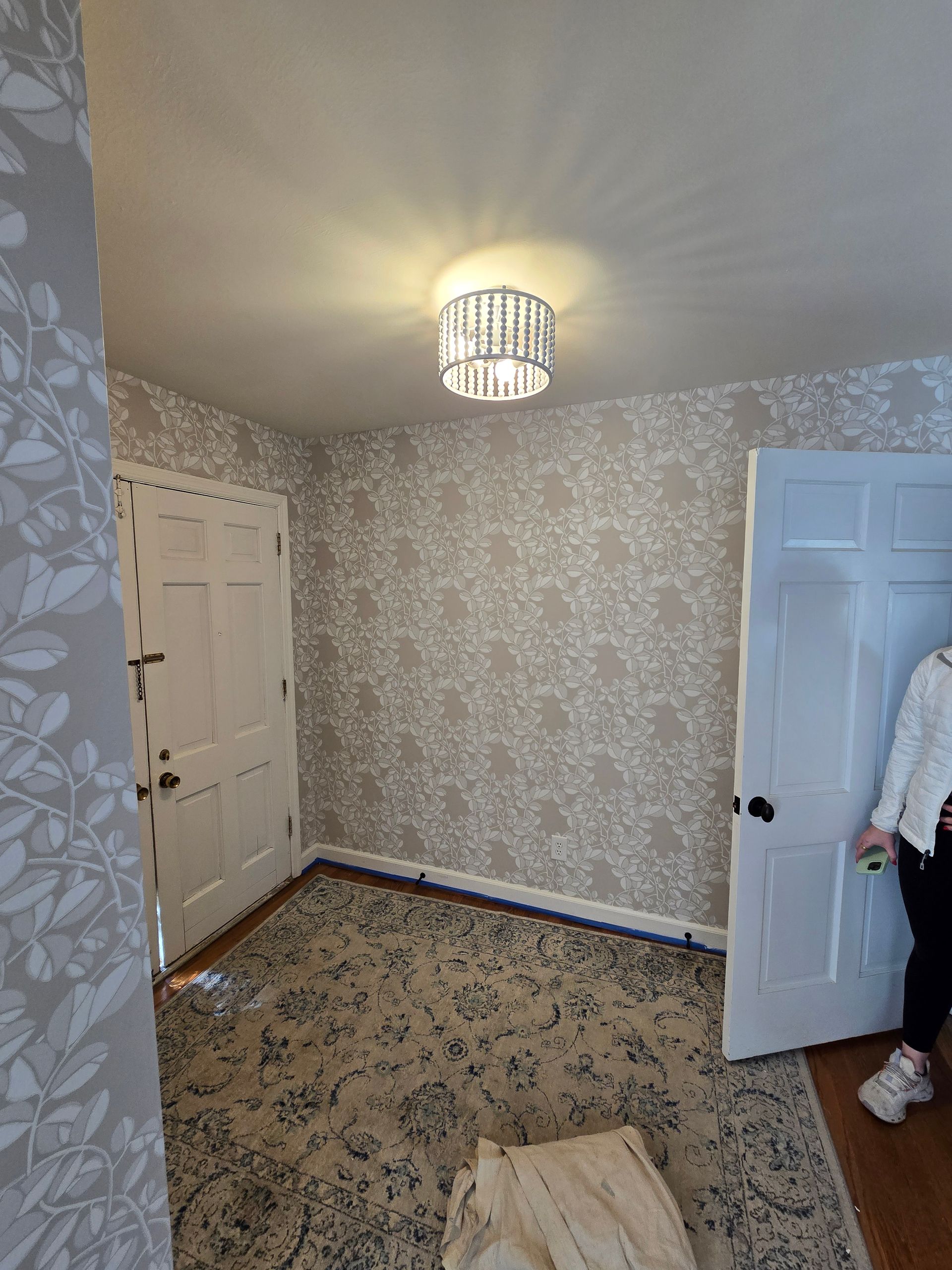 A bathroom with flowers on the wall and a sink