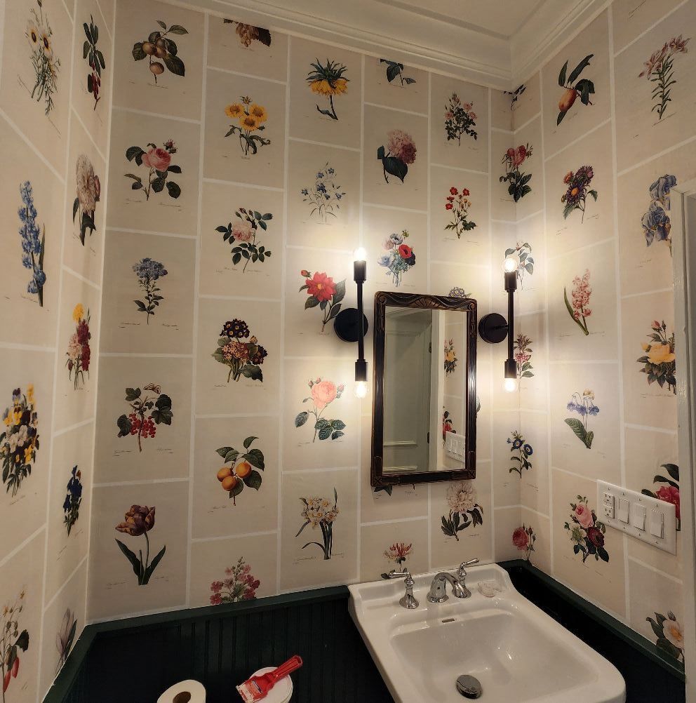 A bathroom with flowers on the wall and a sink