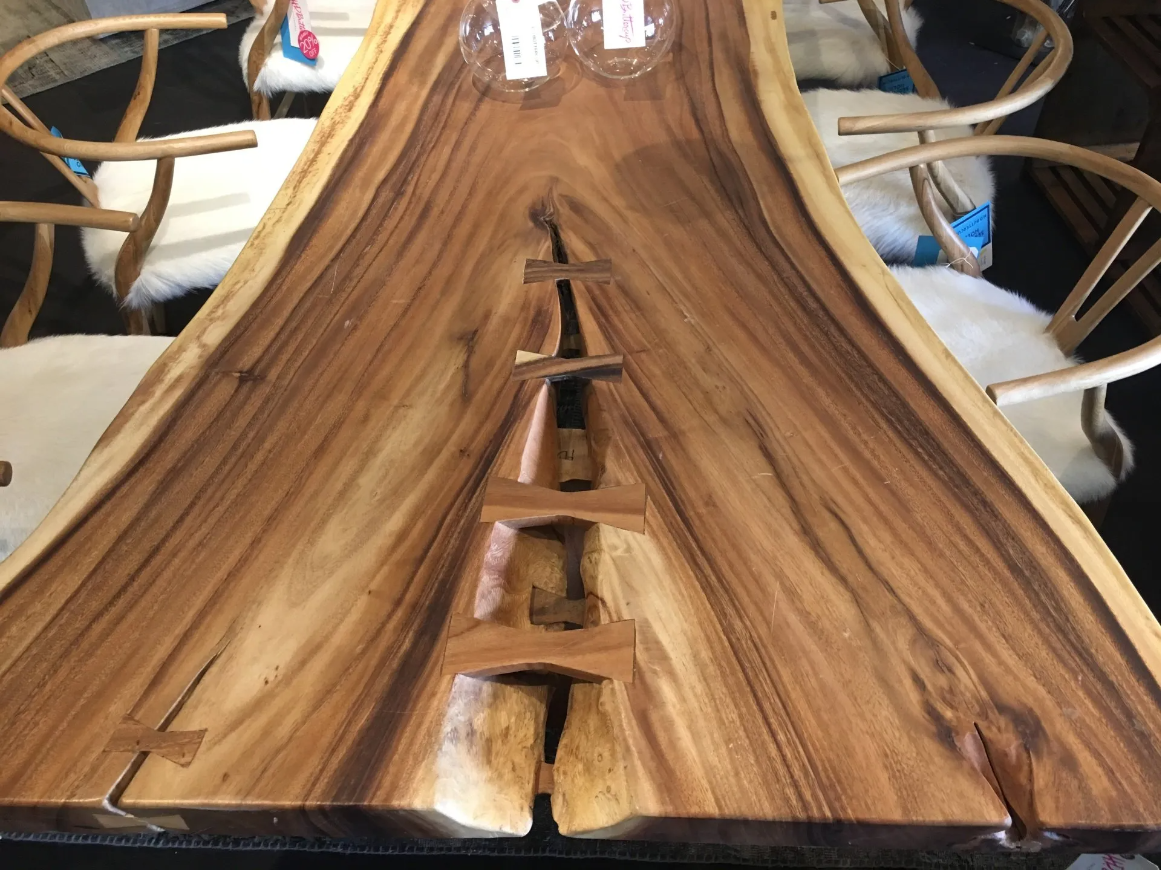 A wooden table with a cross carved into it