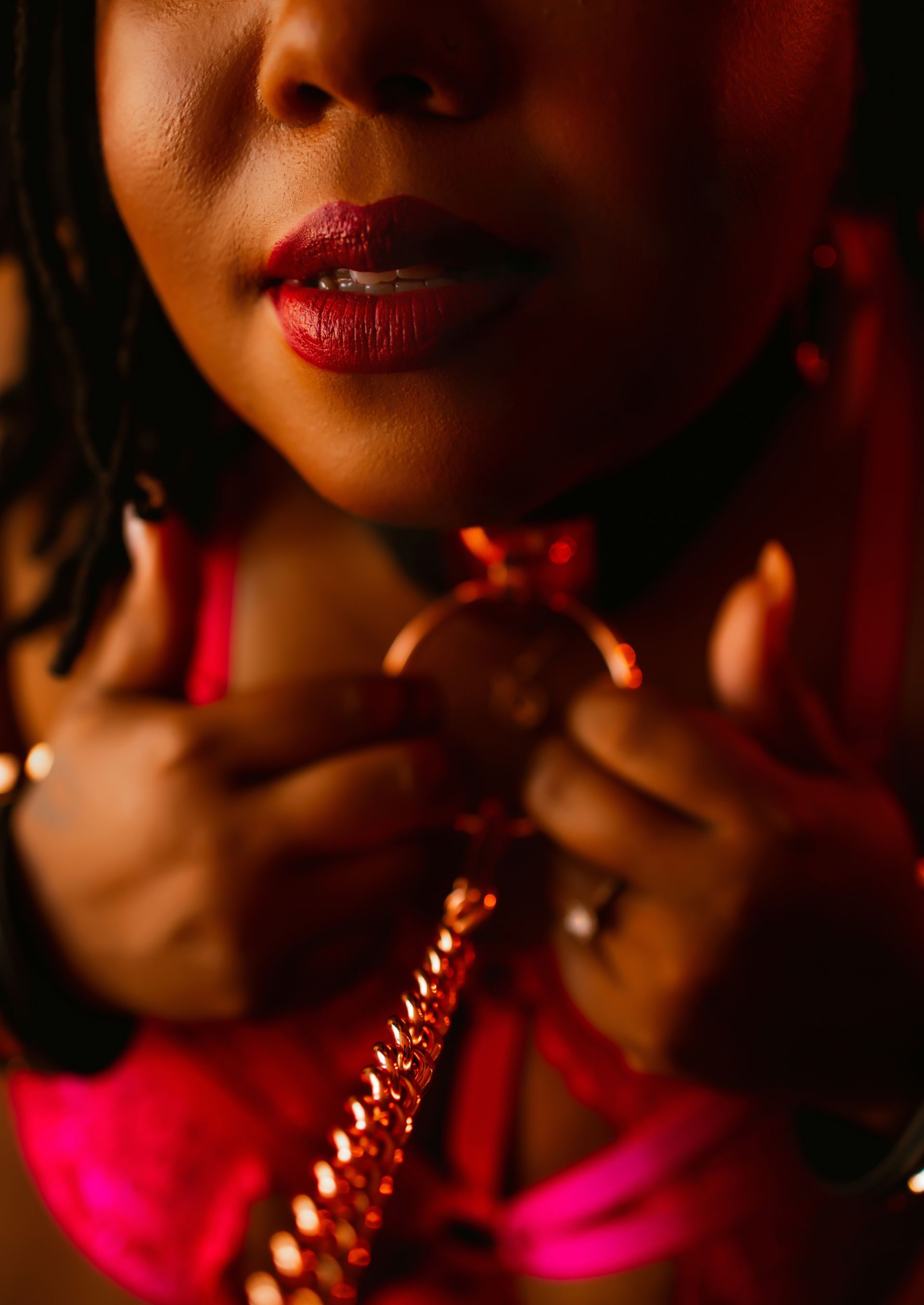 A close up of a woman holding a necklace around her neck.