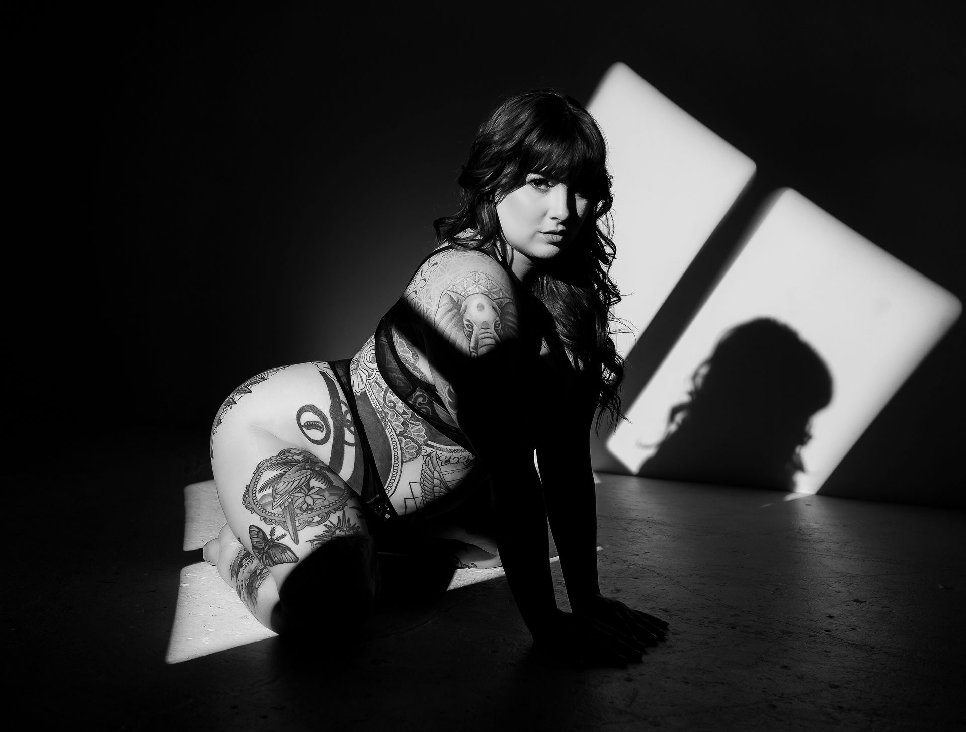 A black and white photo of a woman kneeling down
