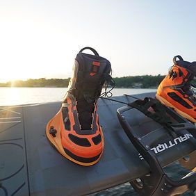 A pair of water ski boots are sitting on top of a boat.