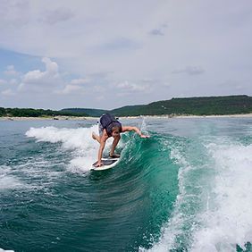 A man is riding a wave on a surfboard in the ocean.