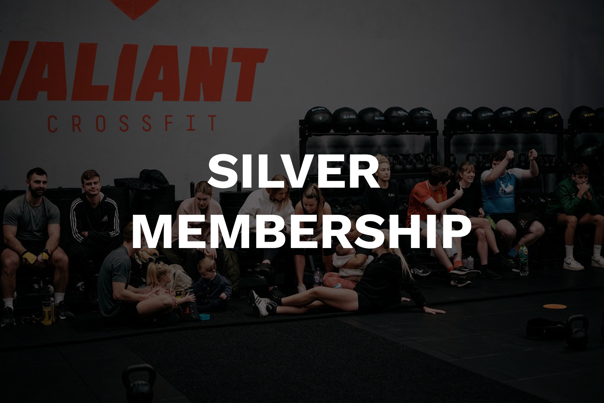 A group of people are standing in a line in a gym.