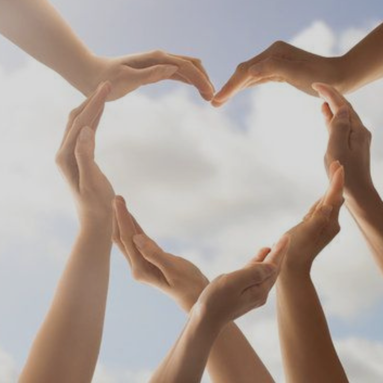 Client, Lilabean  Foundation - Hands forming a heart shape against a bright sky