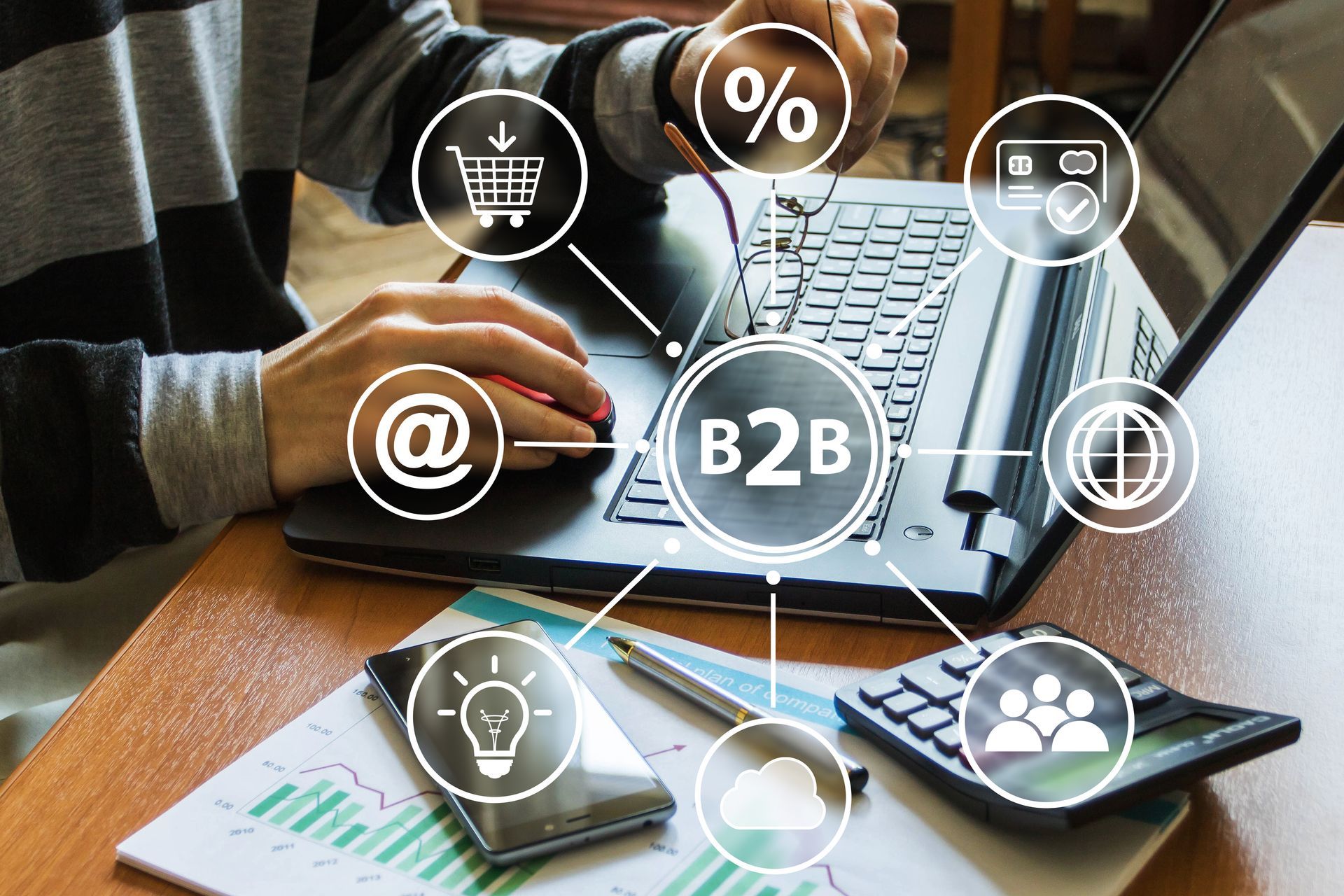 Person using a laptop with B2B graphic overlaid. Icons of shopping cart, percentage, email, and globe.