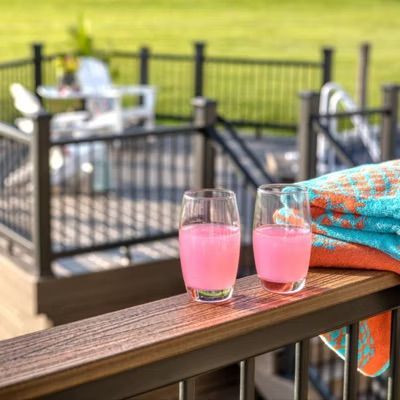 Image of cocktail glasses stood on a Trex Composite Railing