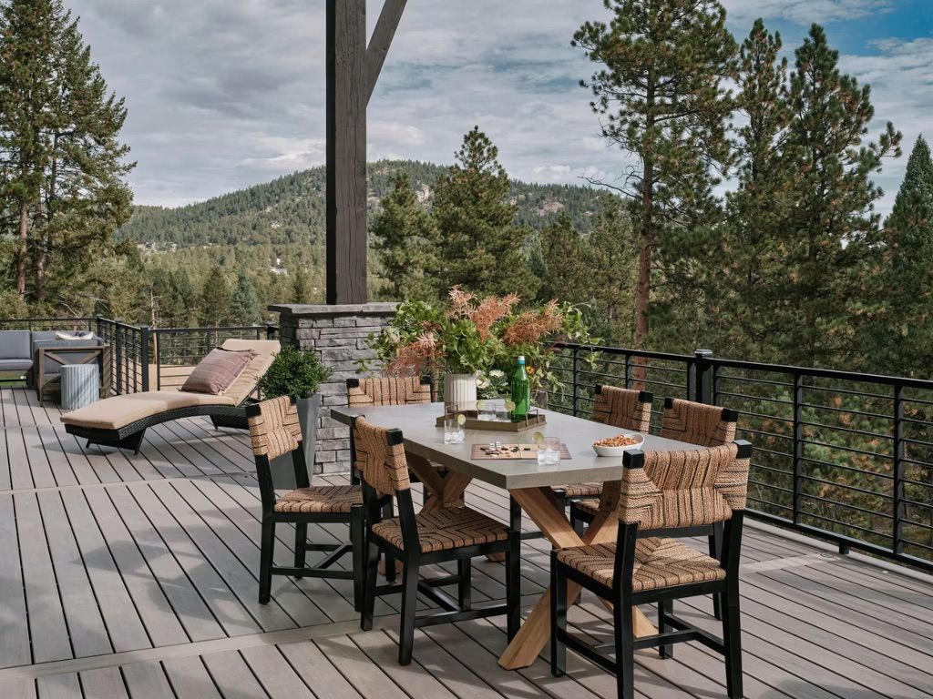 Photo of beautiful Trex composite deck set with a table and chairs, overlooking the hills