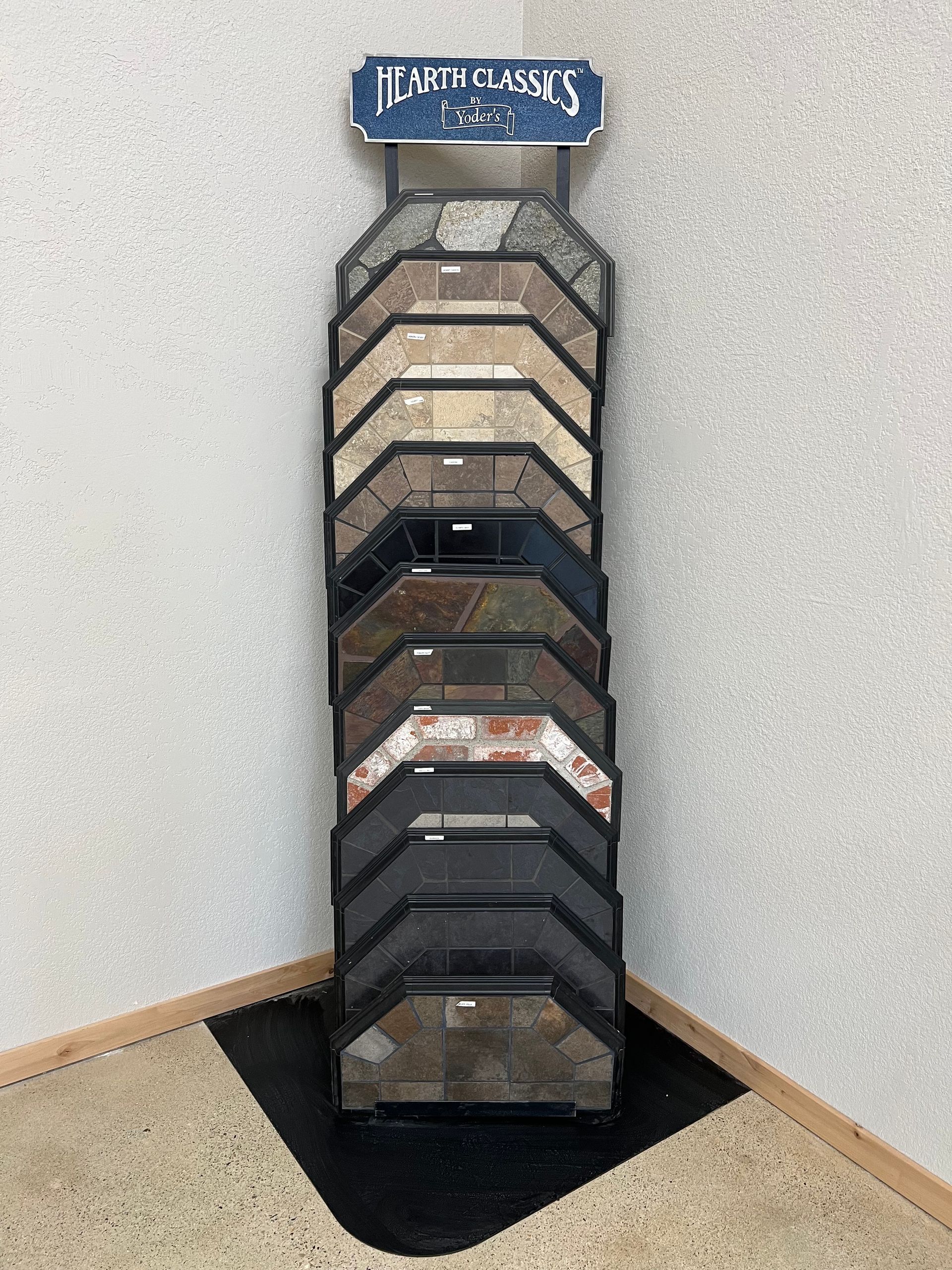 Tile samples displayed on a stand in a corner, showcasing various colors and patterns.