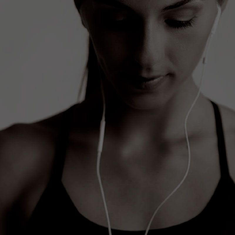 A woman is wearing headphones and listening to music.