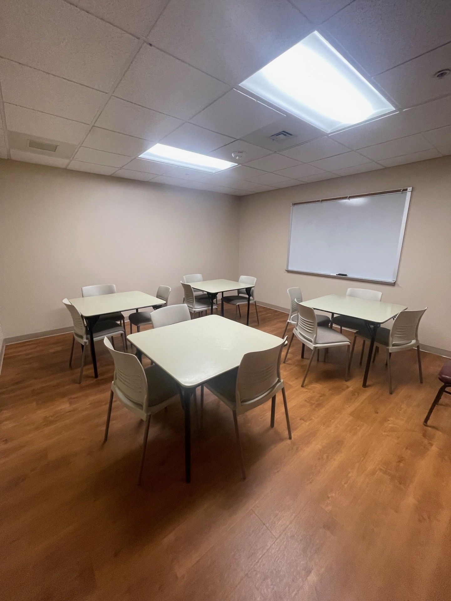 A small conference room set up with card tables.