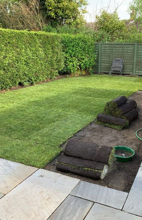 Rolls of Turf Are Sitting on the Ground in a Backyard — Ballina Turf Farm in Wardell, NSW