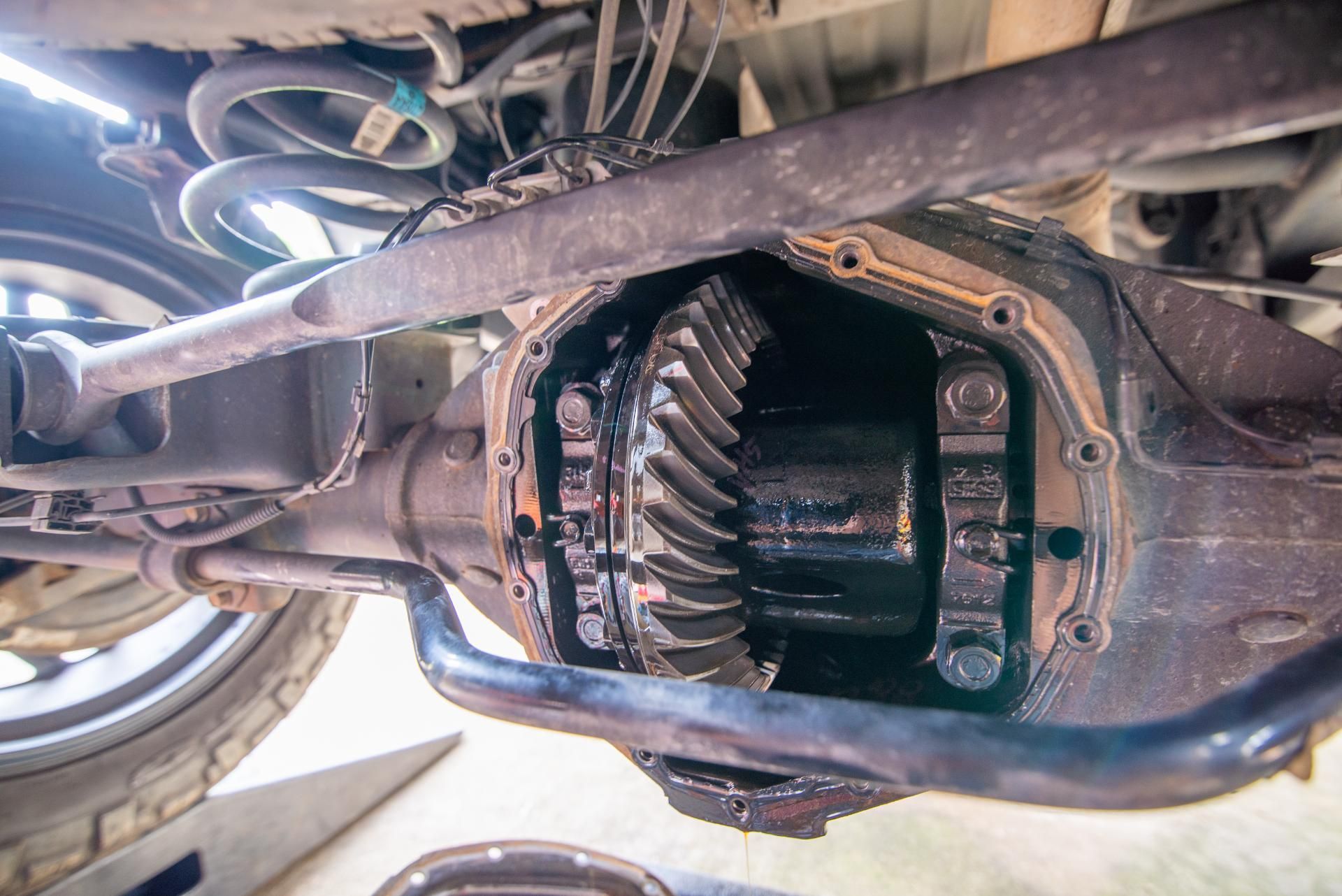 Underbody view of a vehicle’s exposed differential gear assembly inside the axle housing