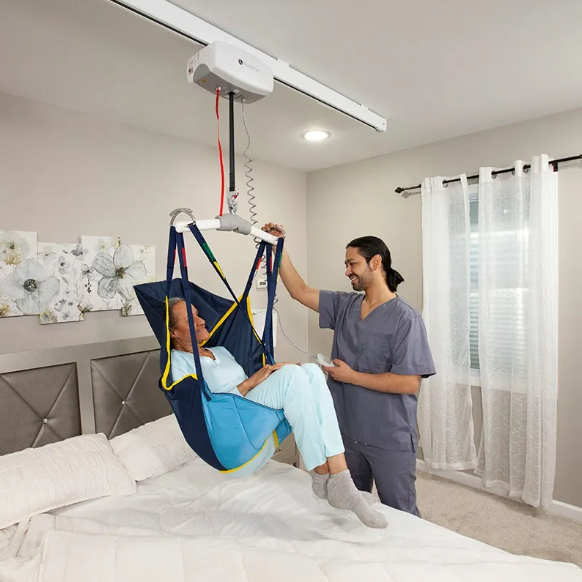 A woman is being lifted in a sling by a man