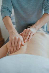 A person is giving a massage to another person.