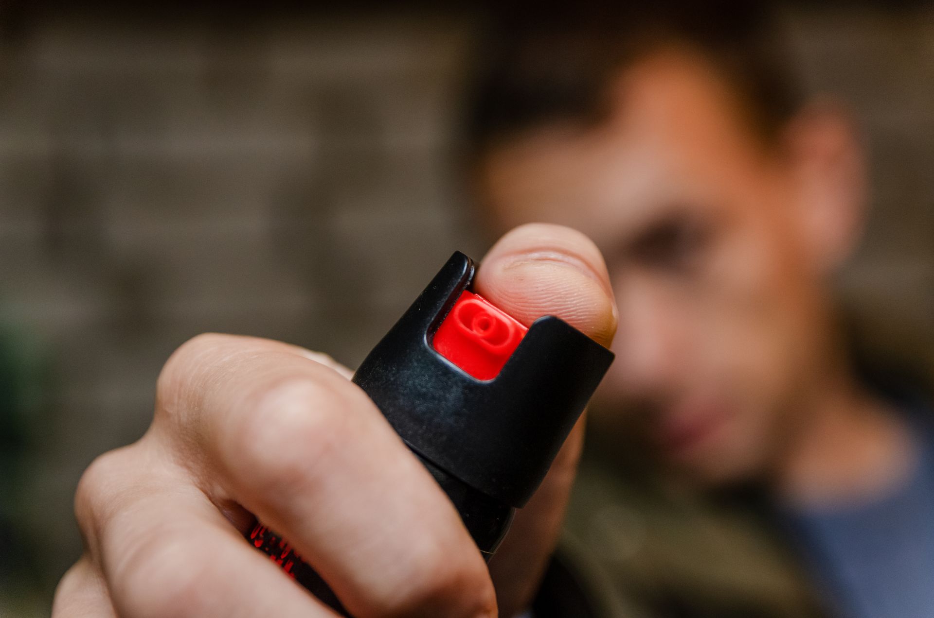 A man is holding a pepper spray in his hand.