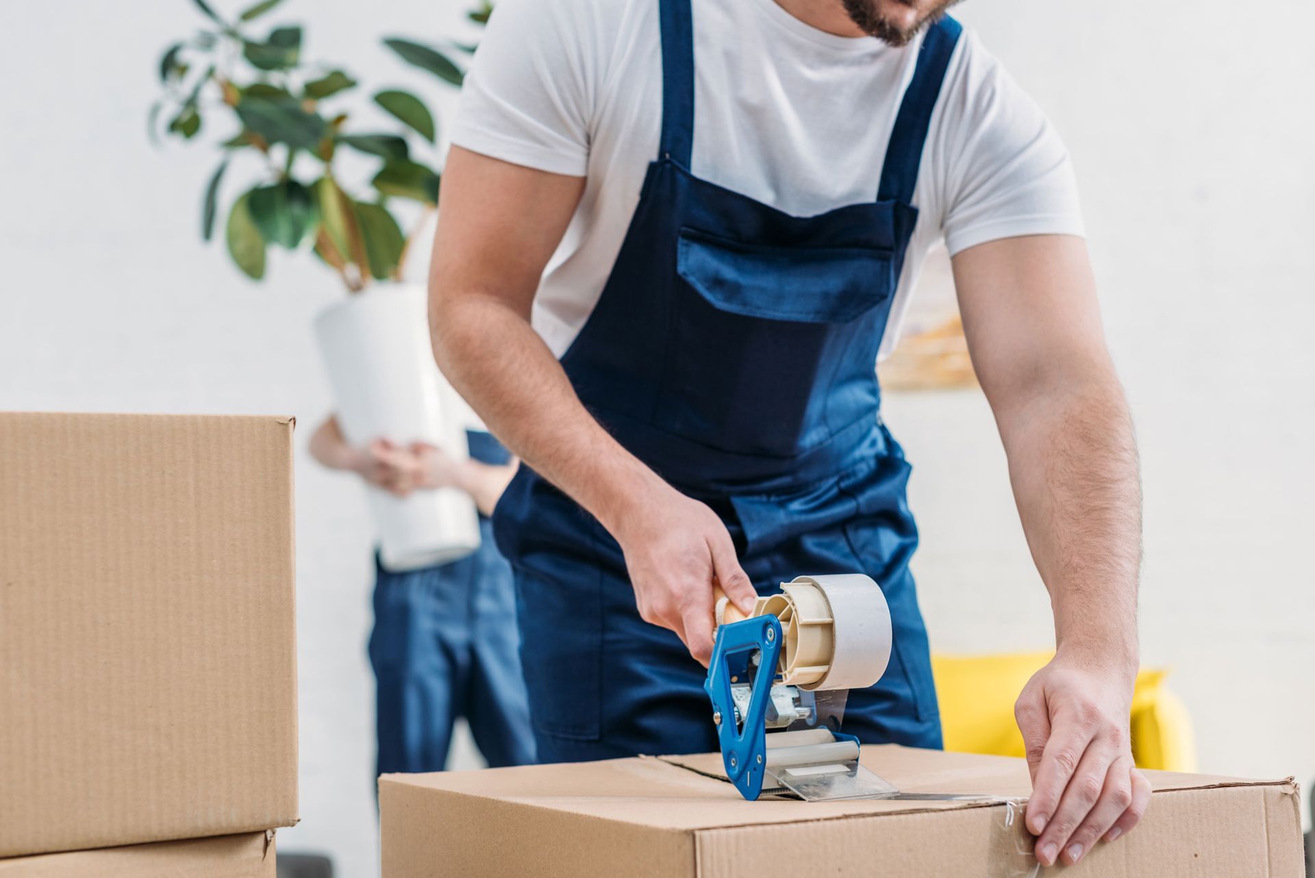 mover taping a cardboard box