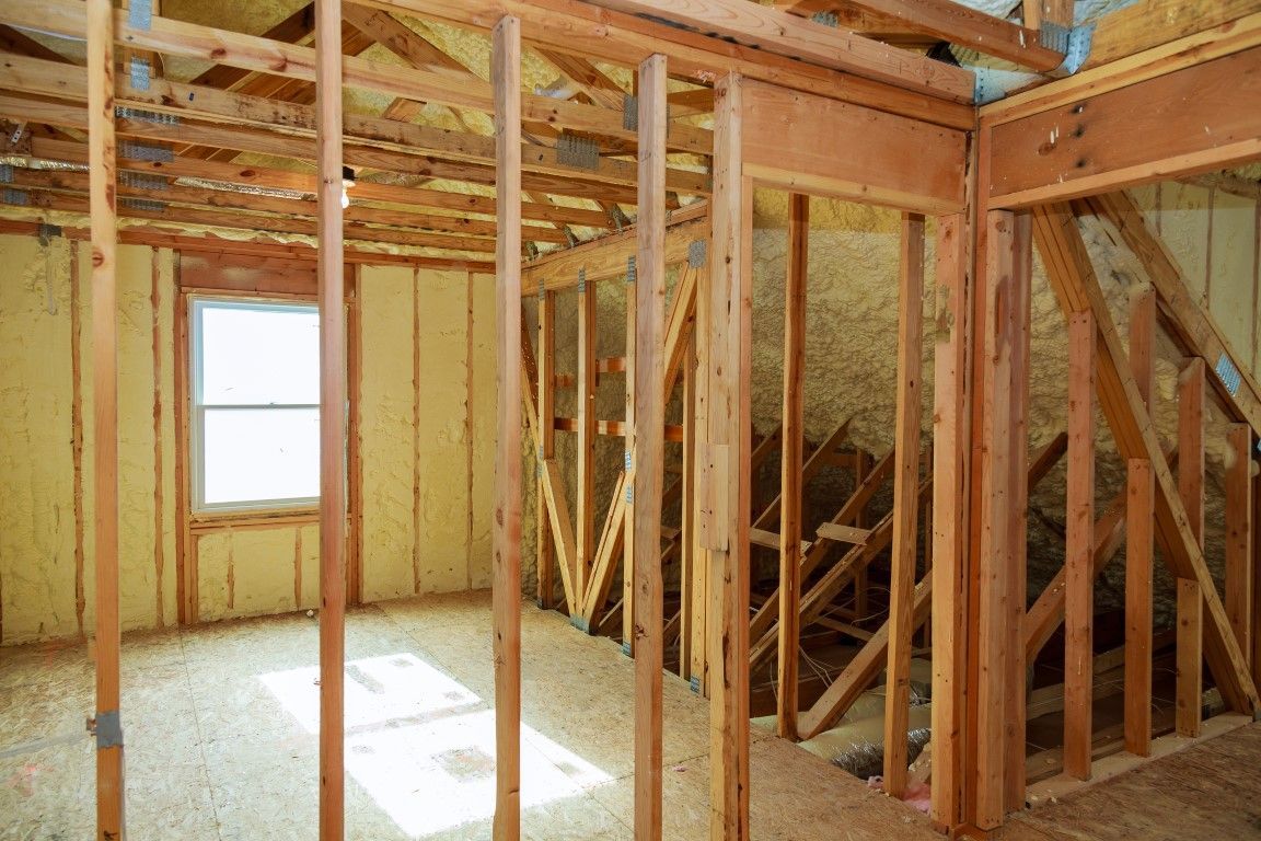 Photo off new construction with spray foam insulation installed at a portion of the wall