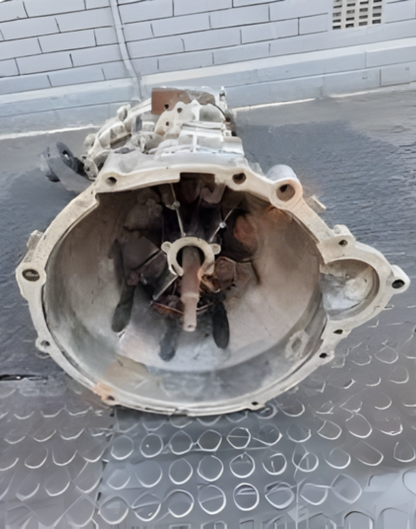 Front view of a Mahindra Scorpio gearbox showing the bell housing and internal components.