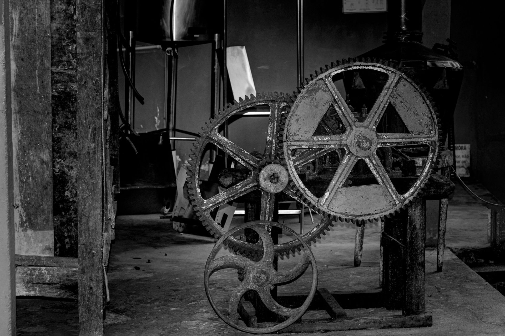 Old industrial gear machinery in a workshop.
