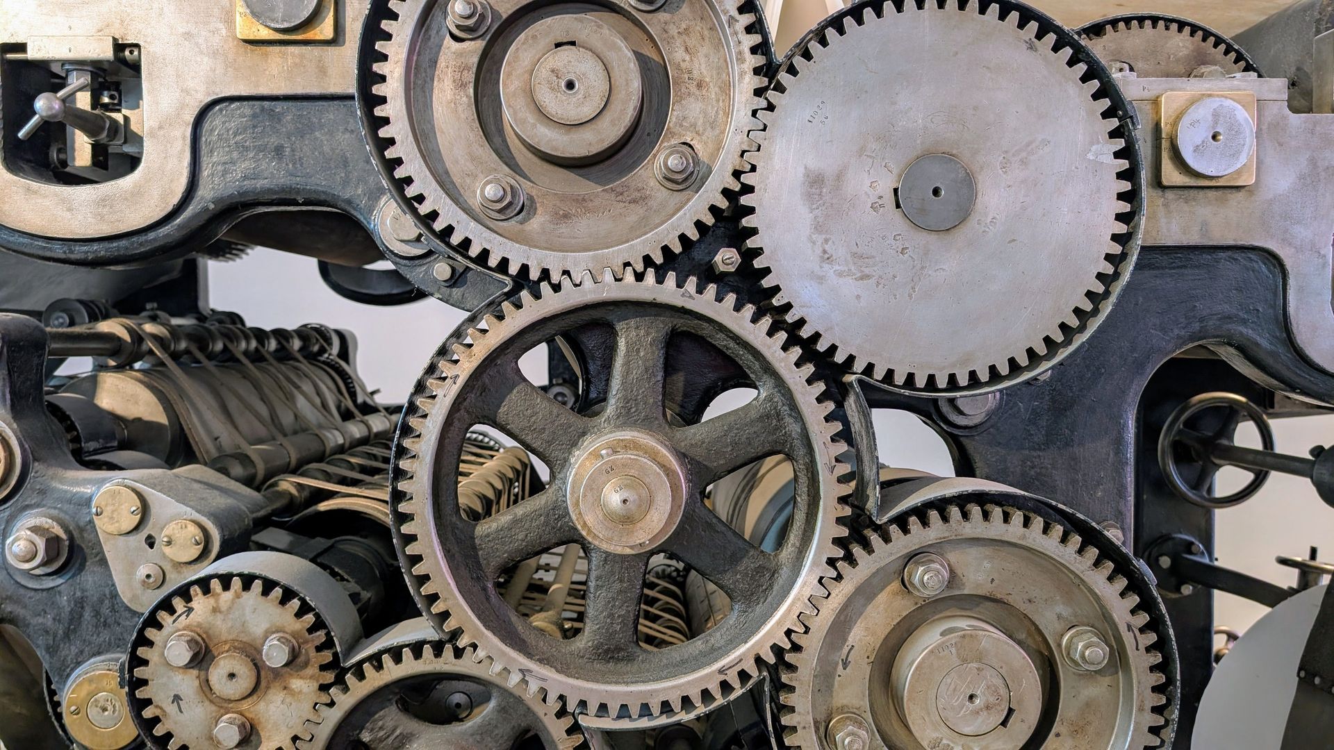 Close-up of metal gears inside industrial machinery.