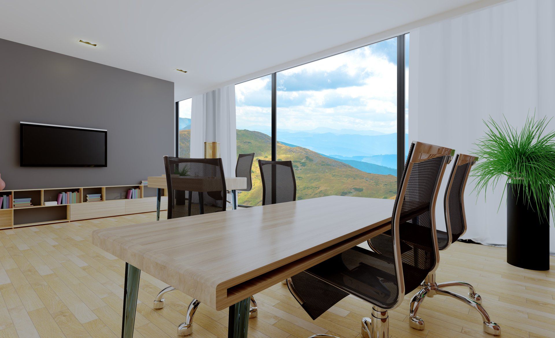 Sala conferenze con ampie finestre, vista sulle montagne, mobili moderni e una pianta.