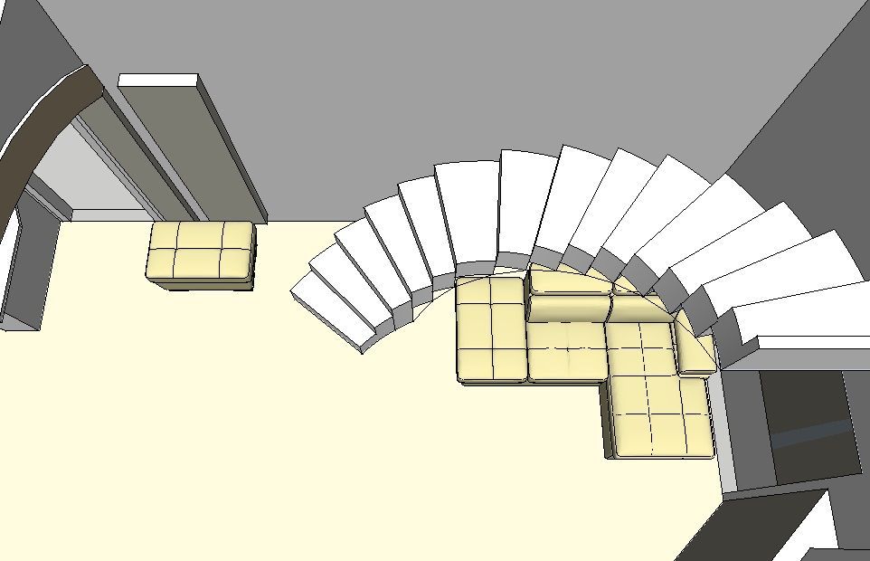 Vista dall'alto di una scala curva con mobili color beige e marrone chiaro. Pavimento beige chiaro, pareti grigie.