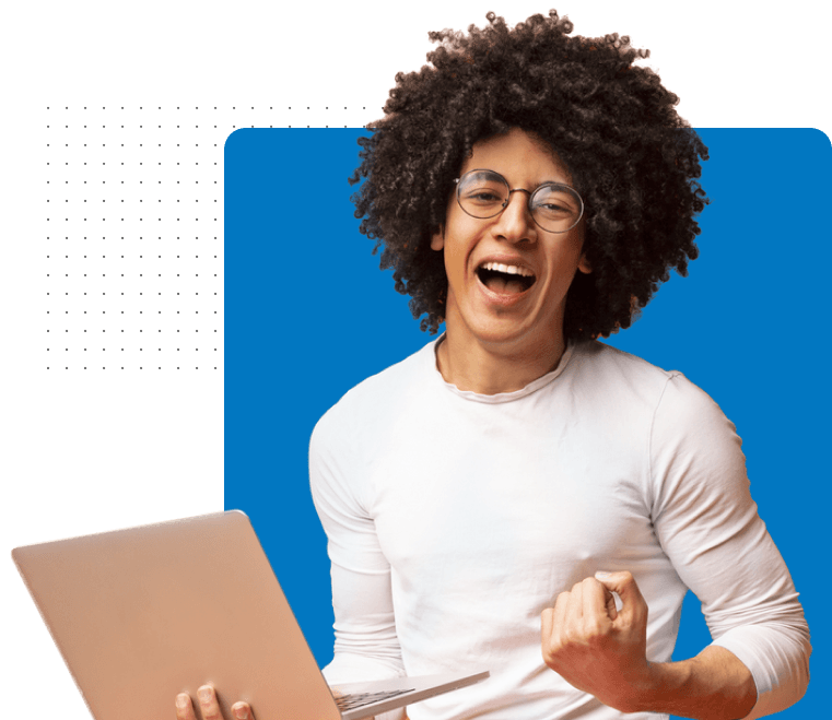 Man holding laptop, smiling widely, fist raised in front of blue background.
