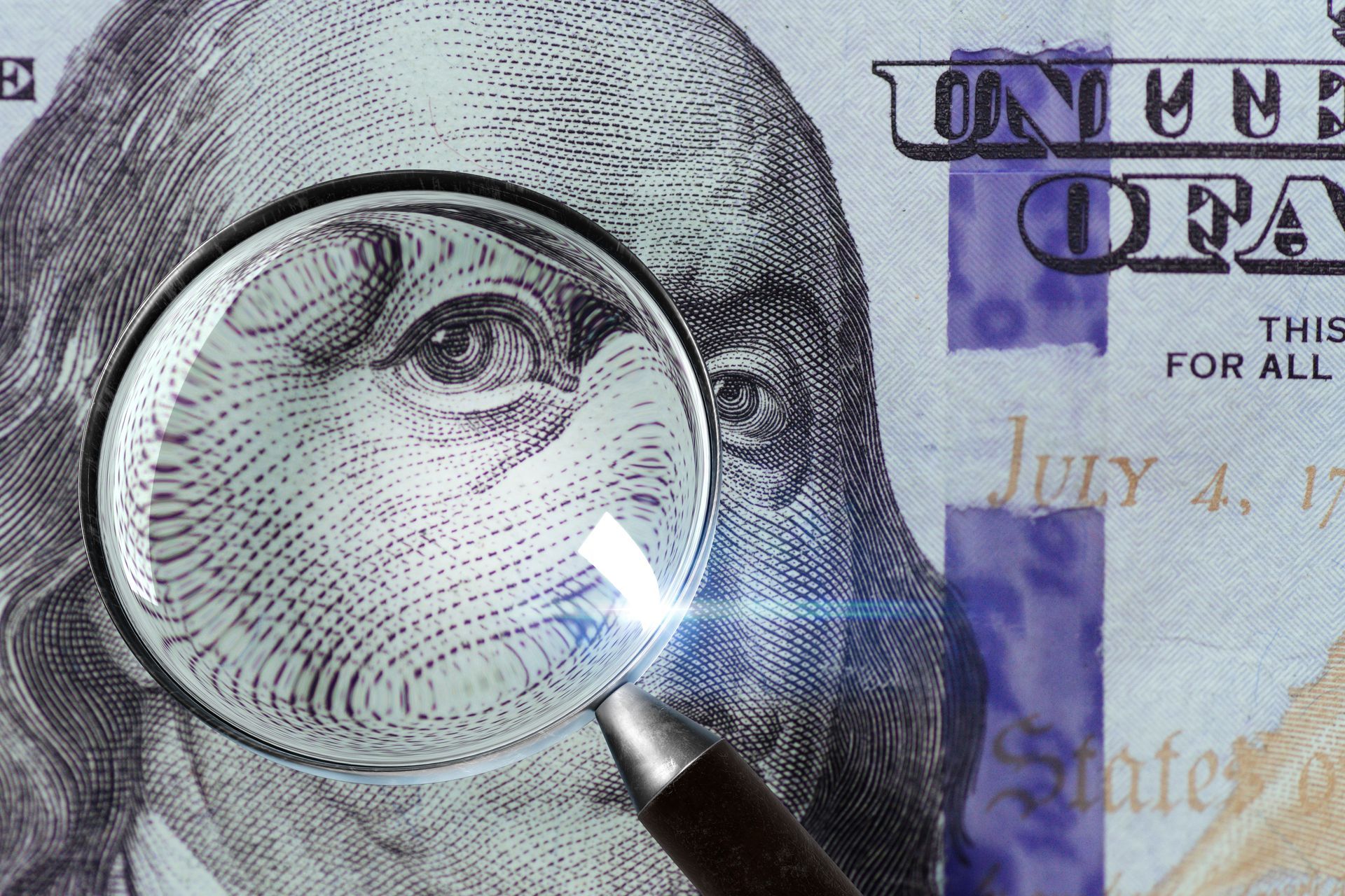 Magnifying glass over George Washington on a U.S. dollar bill, highlighting the engraved eye
