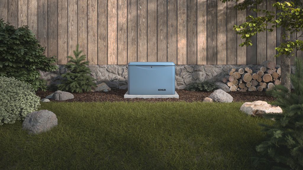 Blue outdoor storage box centered on a lawn against a wooden fence and stone border, with shrubs and rocks nearby