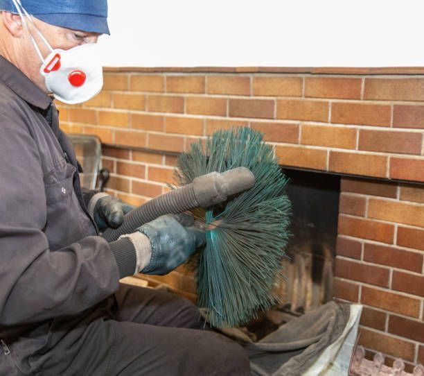 The chimney sweep is finishing cleaning.