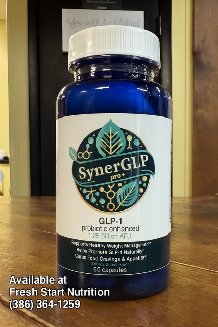 Blue bottle of SynerGLP dietary supplement on a wooden surface with a store's contact information.