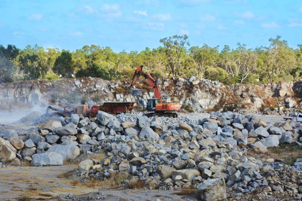 Orange Digger Working At Quarry — Quarry Products In Moranbah, QLD