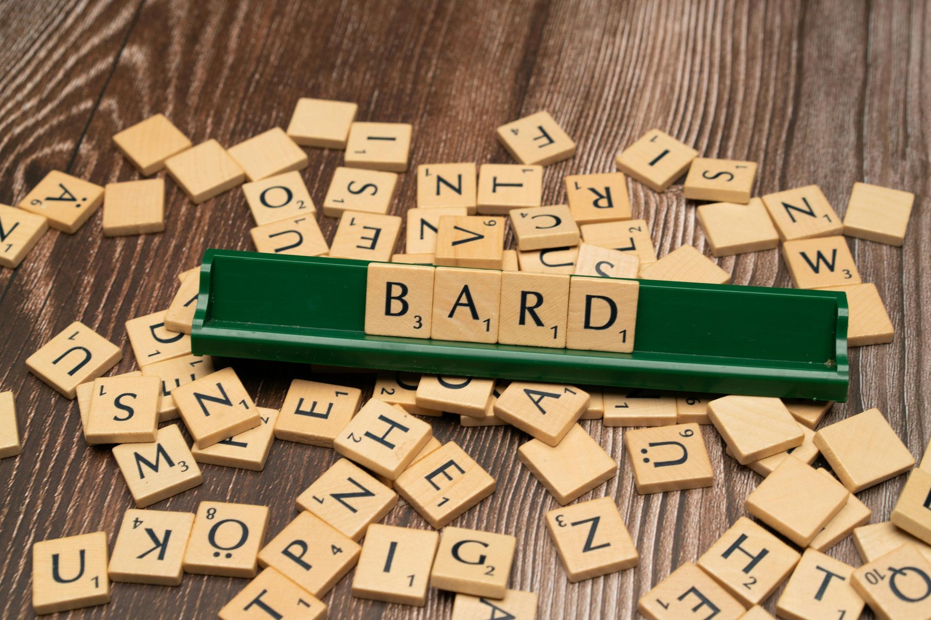 A scrabble board with the word bard written on it