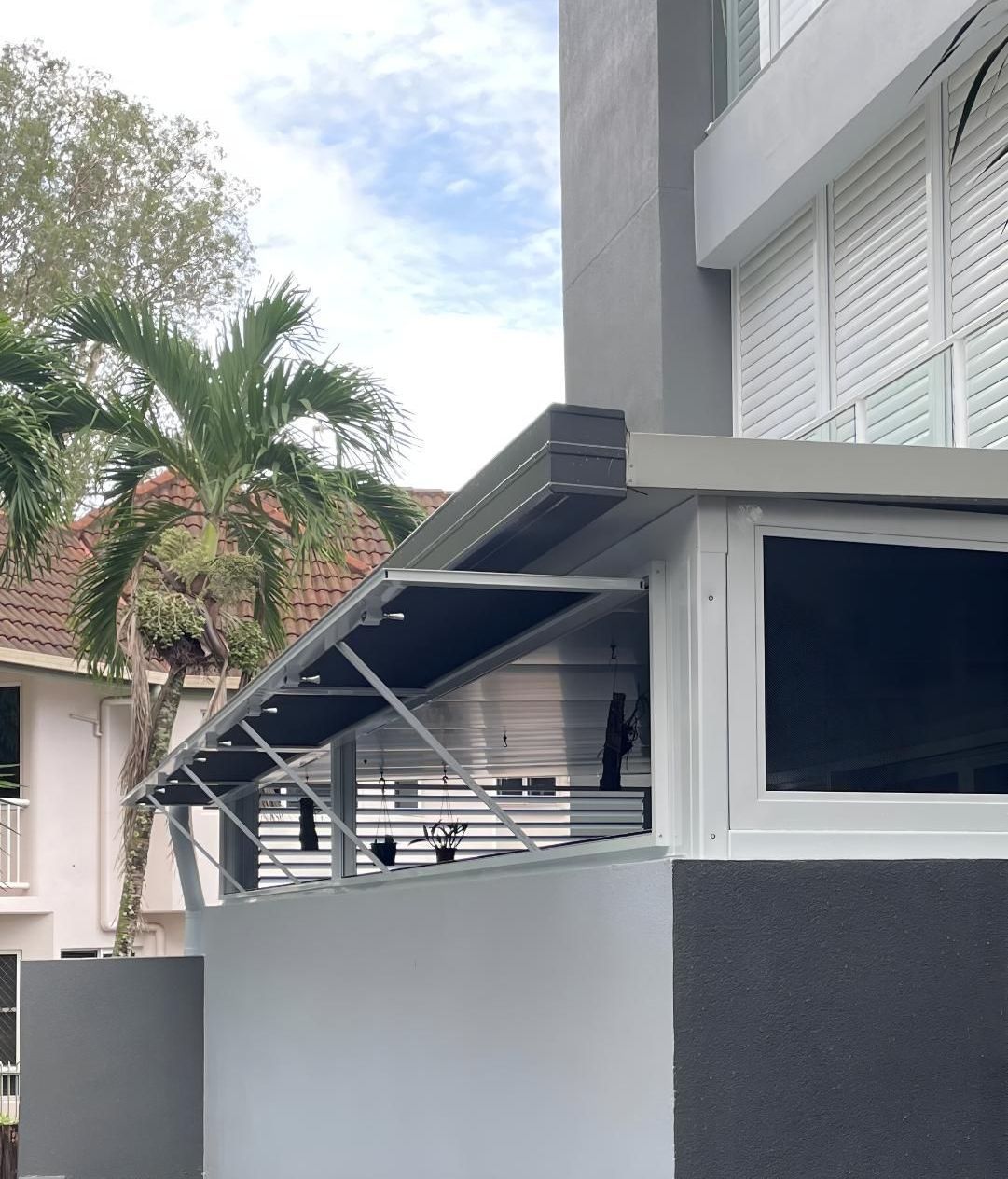 A Gray and White Building With a Black Awning Over a Window — A1 Security Screens Cairns In Smithfield, QLD