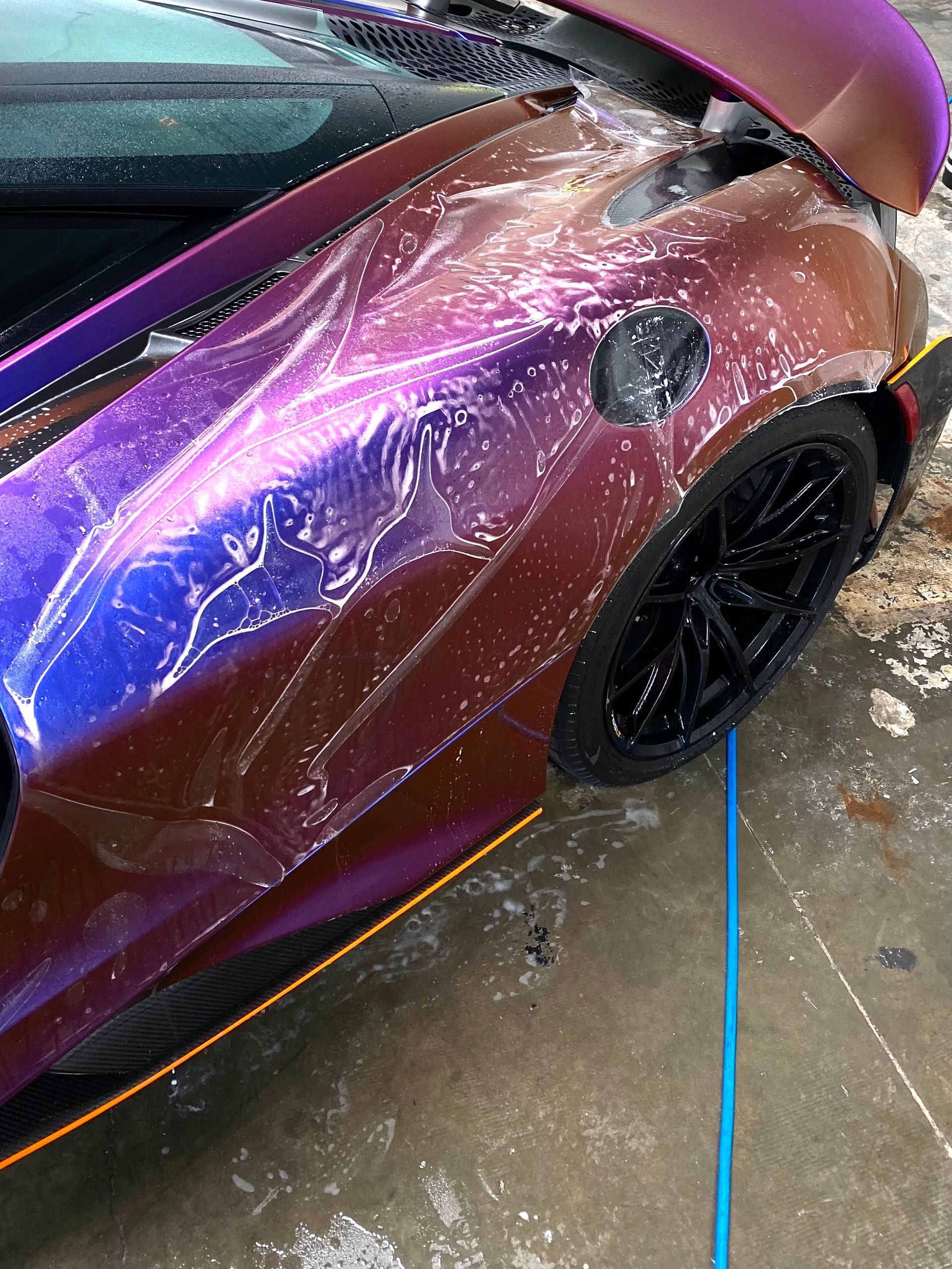 A close up of a purple car with the hood up