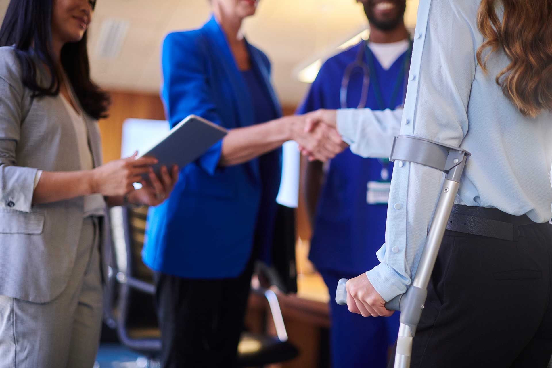 A group of four people, including an injured employee, together for a workplace injury assessment.