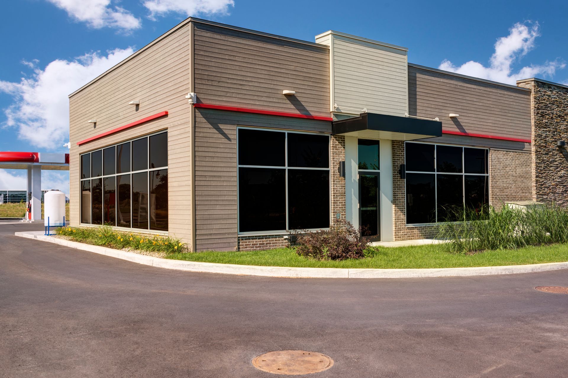 Commercial storefront with dark-tinted security windows.