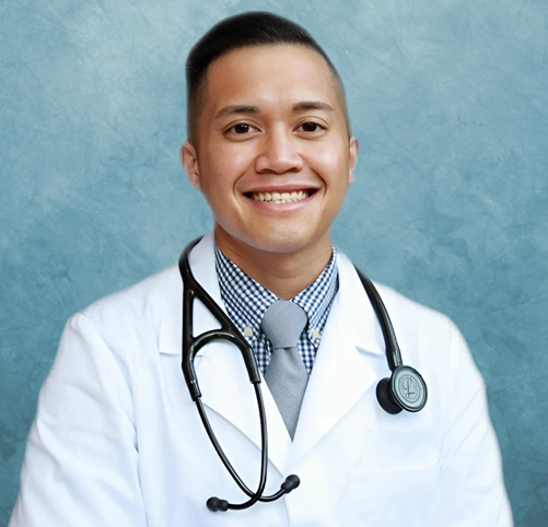 Doctor in a white coat with a stethoscope smiling at the camera.