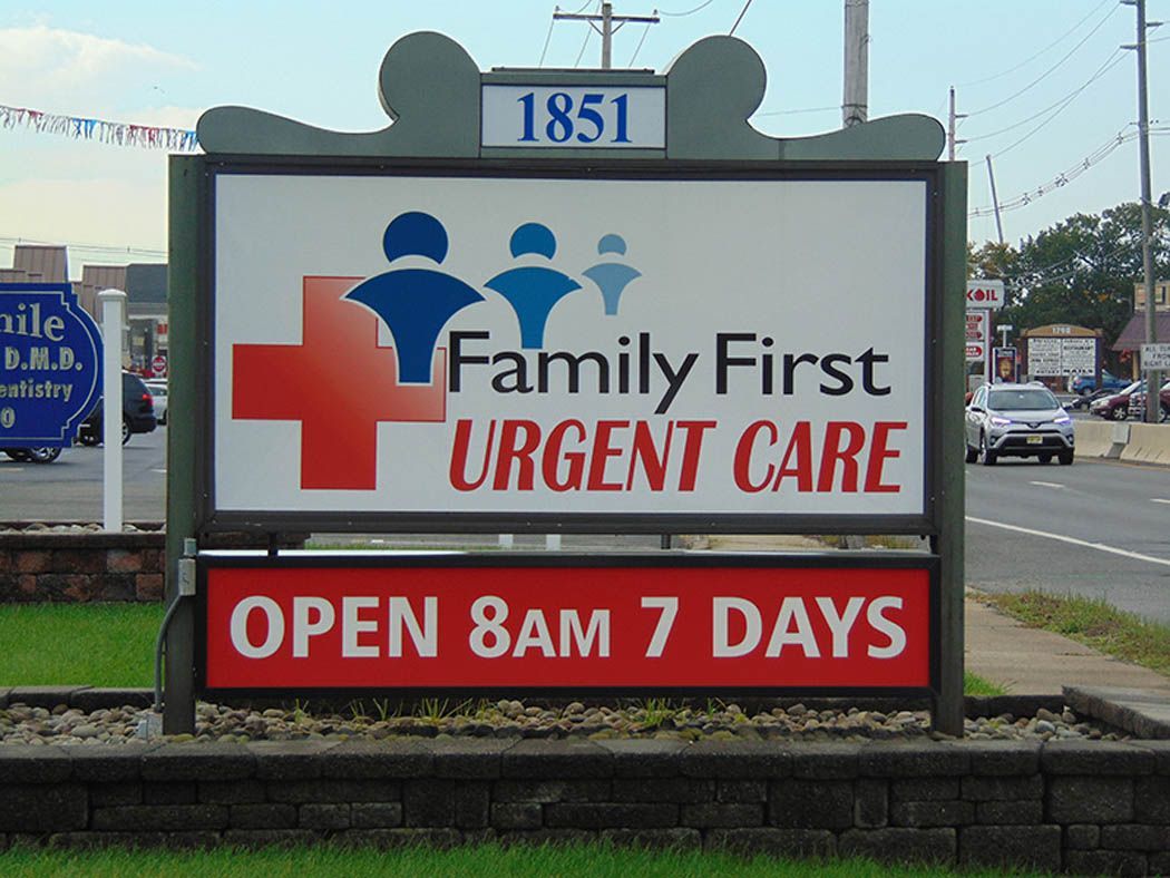 Sign for Family First Urgent Care: white background, red cross logo, and hours: open 8 am 7 days.