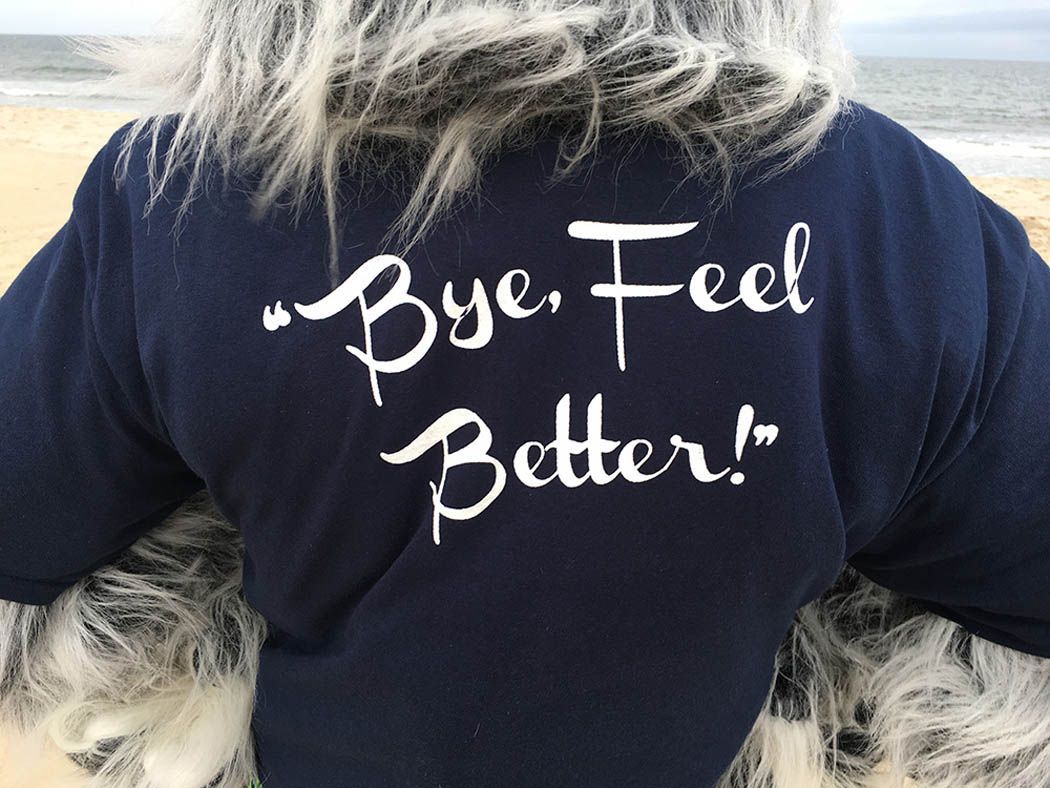 Person wearing a dark blue shirt with the words 