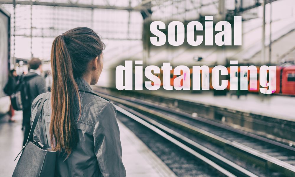 Woman waiting on a train platform; text