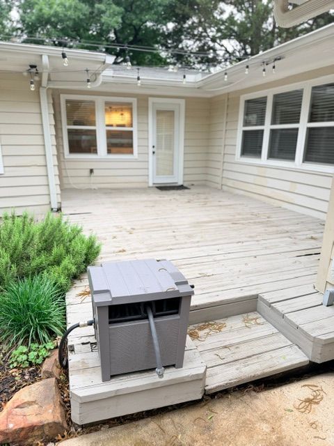 Before photo of a weathered backyard deck with faded boards and steps at a residential home in Dallas, TX.