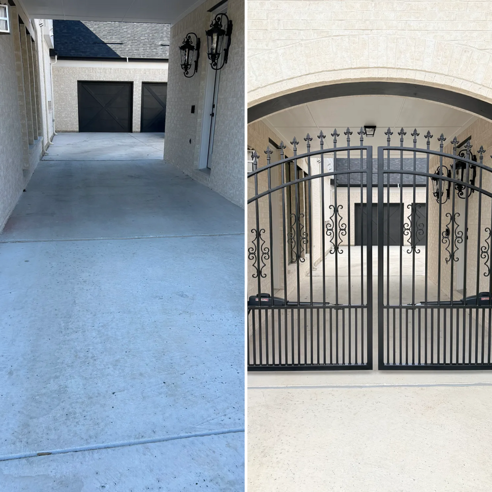 Concrete driveway beside a stucco house, with a black wrought-iron gate over a small arched entry.