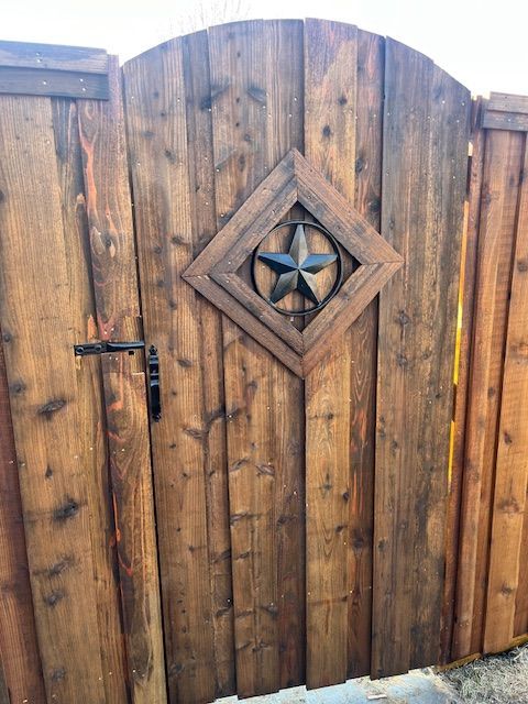 Wooden arched gate with a diamond-shaped decorative star in the center