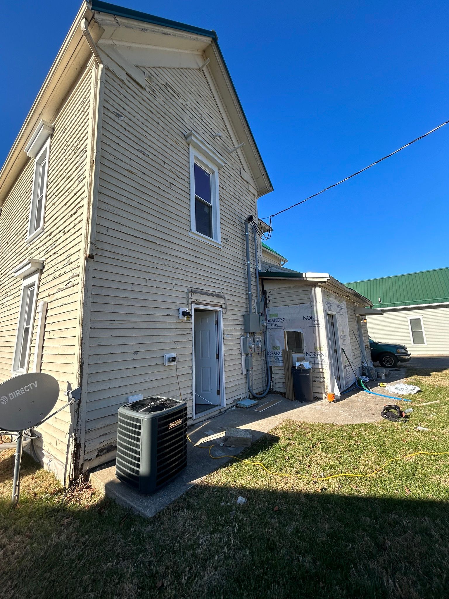 A house with a satellite dish on the side of it.